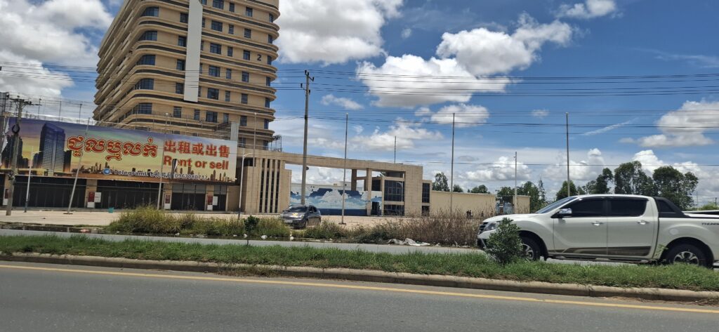 A reported scam compound called Mango Park in Cambodia's Kampong Speu province, with a "Rent or sell" sign posted, on August 13, 2025. (Danielle Keeton-Olsen/Mekong Independent)