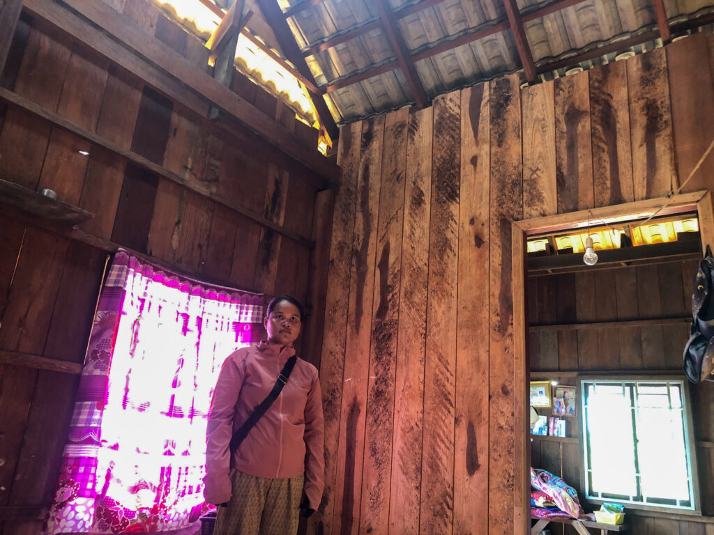 Khieu Chhorvy observes the state of her wooden house after returning to her home in Cambodia's Preah Vihear province on January 15, 2026. (Meng Kroypunlok/Mekong Independent)