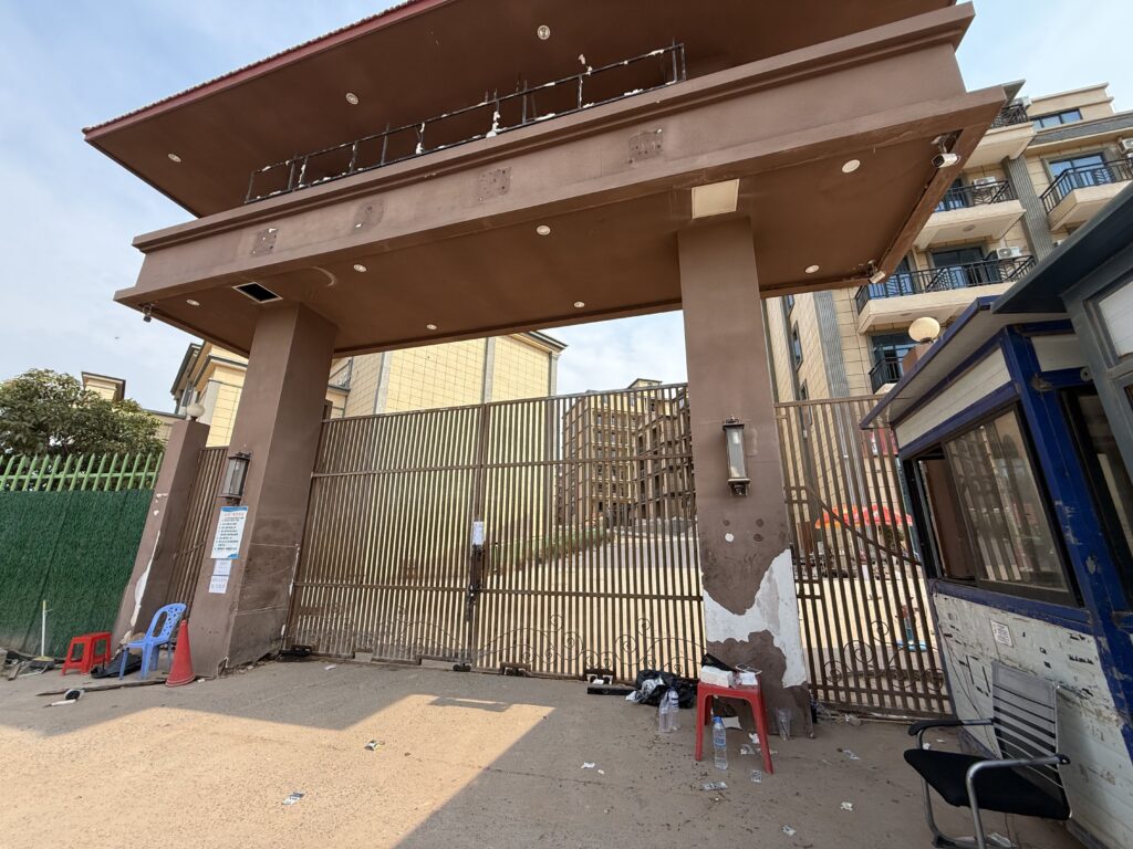 A locked gate blocking off villas and housing in the Long Bay Dara Sakor resort, left unmonitored by security after an apparent exodus from the compound, on February 11, 2026 in Cambodia's Koh Kong province. (Mech Dara/Mekong Independent)