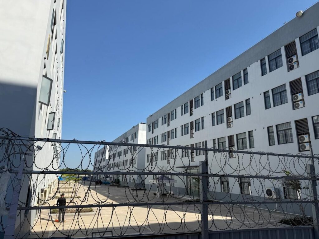 Behind the barbed wire of Silver Star casino, only one worker was visible sweeping the sidewalk, in Cambodia's Bavet city on February 1, 2026. (Mech Dara/Mekong Independent)