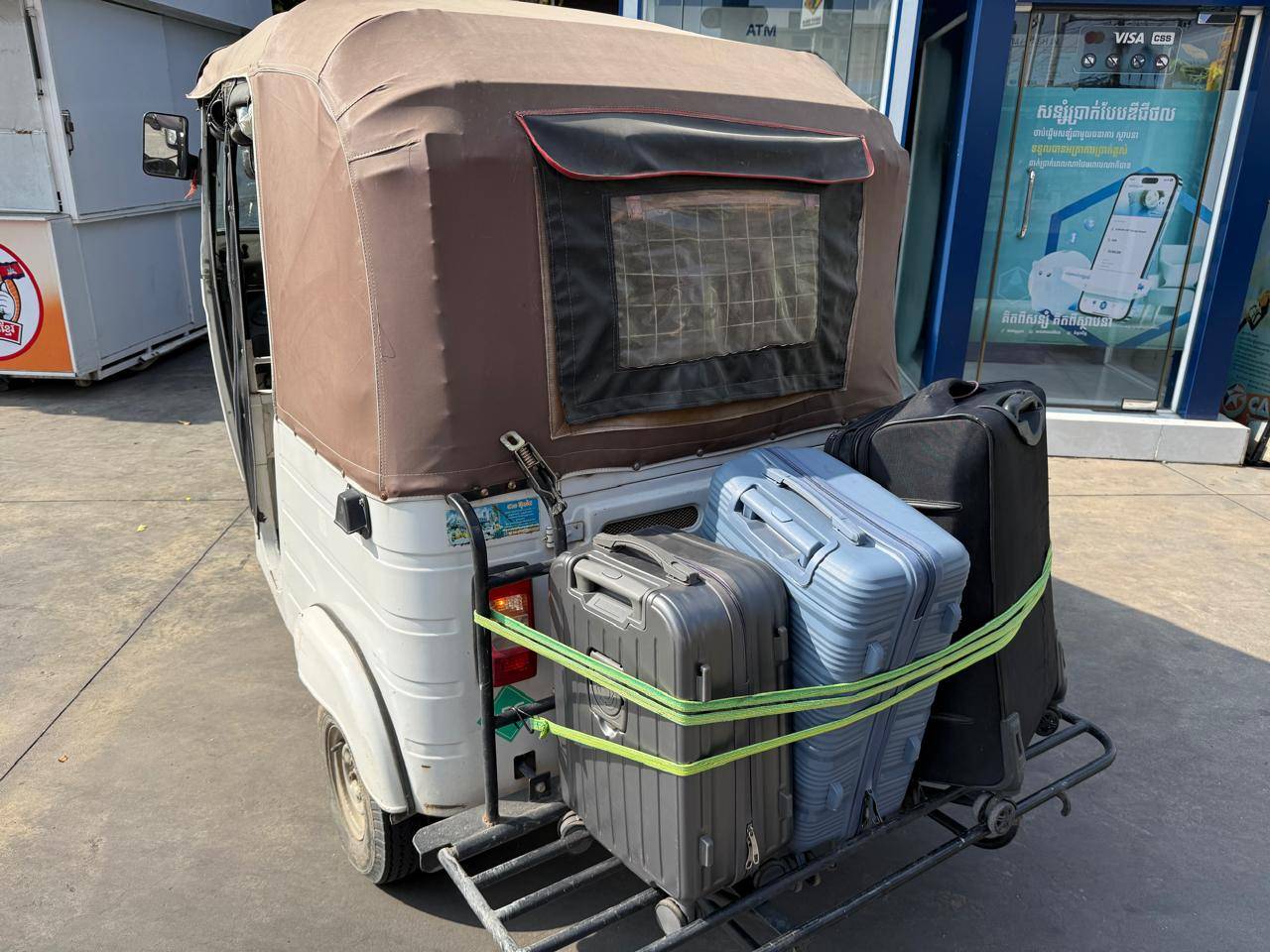 Foreign workers stranded in Cambodia after being evacuated from scam compounds transport their luggage on a tuk-tuk in Phnom Penh on April 7, 2026. (Mech Dara/Mekong Independent/Creative Commons)