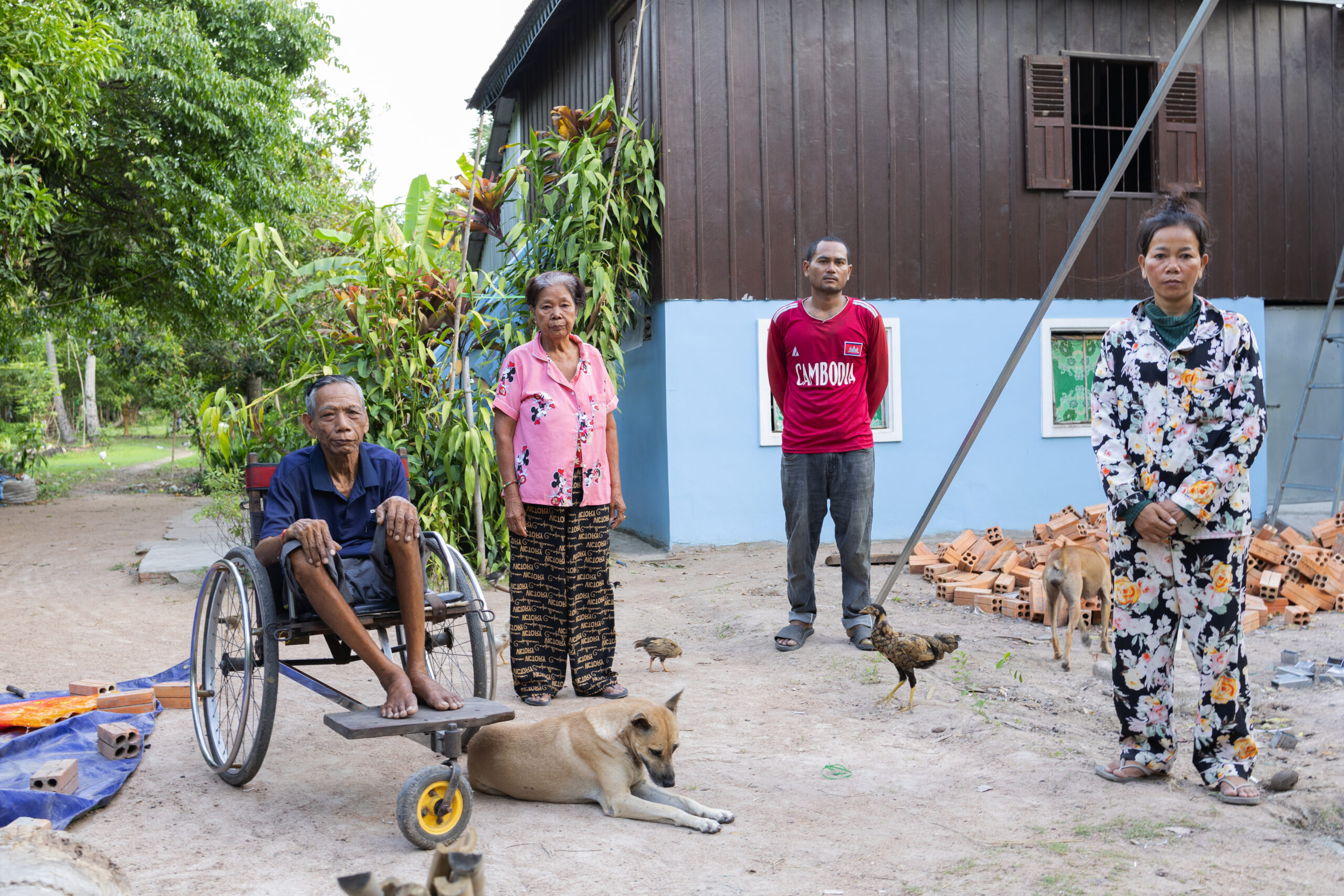 The surviving family of Chea Phally and Chea Phalla, sisters who were both killed on their way to work in a garment factory on May 23: father Sou Chuen, 73, mother Chea Vanny, 72, Lim Sokly the husband of Chea Phalla, and Chea Malai, 40, the middle sister, at their home in Kampong Chhnang province on June 9, 2026. (Choulay Mech/Mekong Independent)