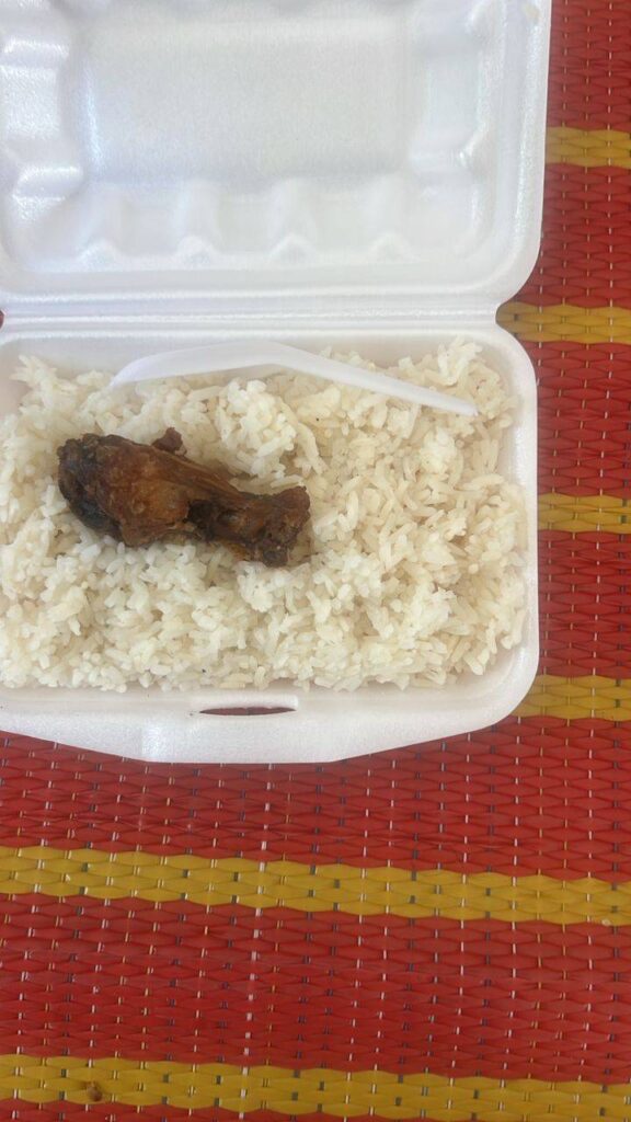 A box of rice and a chicken wing, which was reportedly an example of the only meal that is provided daily to people in a new temporary detention center in Cambodia's Takeo province. (Supplied)