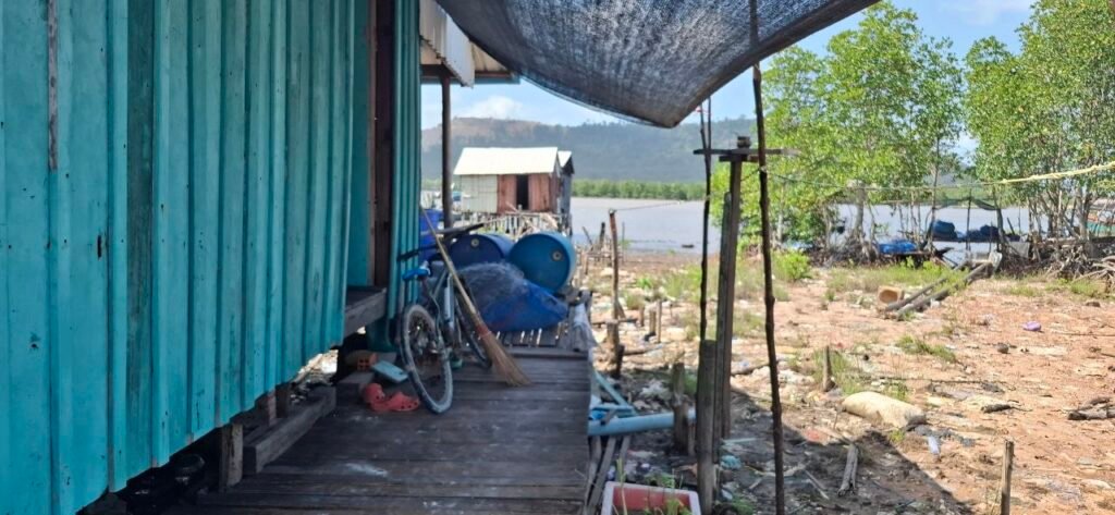 The walkway to a house in Ong village, with a bicycle out front, on July 11, 2026. (Danielle Keeton-Olsen/Mekong Independent/Creative Commons)