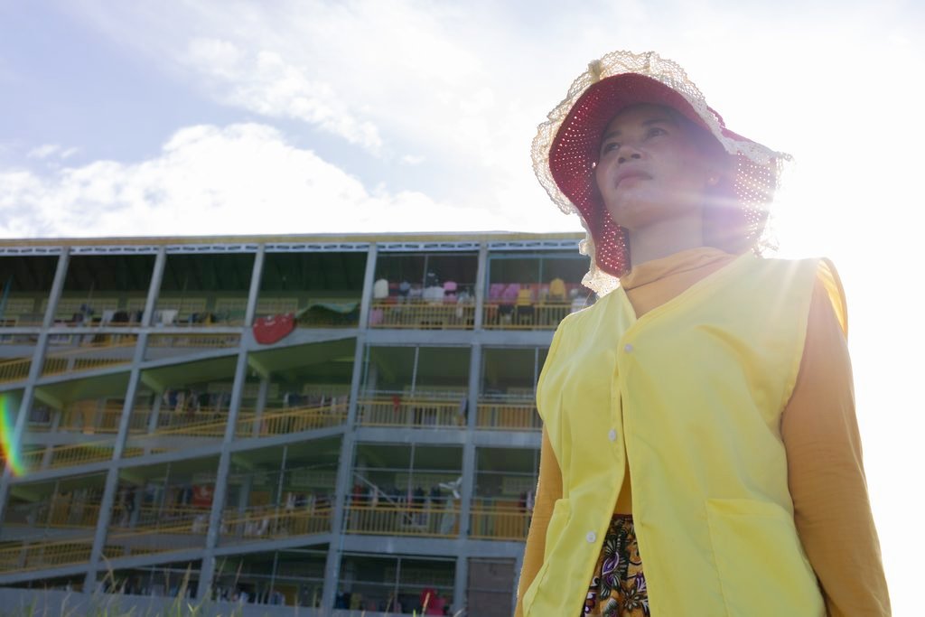 Sokhorn stands in the sun outside her rented room on the outskirts of Phnom Penh on DATE. (Mech Choulay/Mekong Independent)