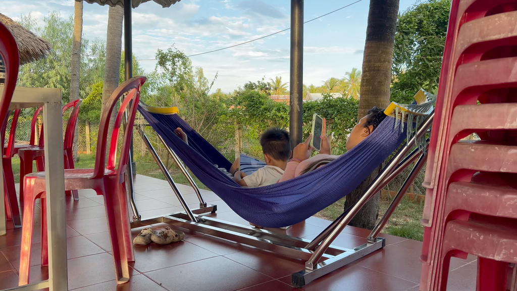 Thư and her son sit together in a hammock in Central Vietnam on September 19, 2026. (Danielle Keeton-Olsen/Mekong Independent)