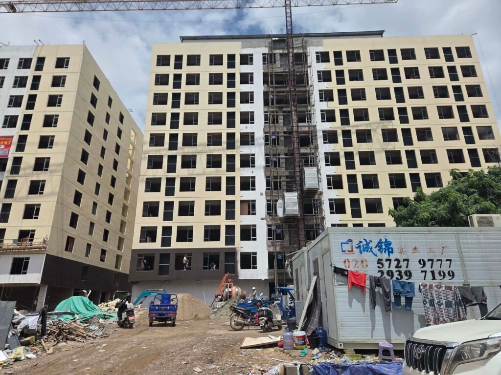 A 10-story building that's still under construction within the site of a previous scam crackdown at the "Kilometer 16" area of one of Vientiane's national roads, in late July 2026. (Apichart Sopapong/Mekong Independent)